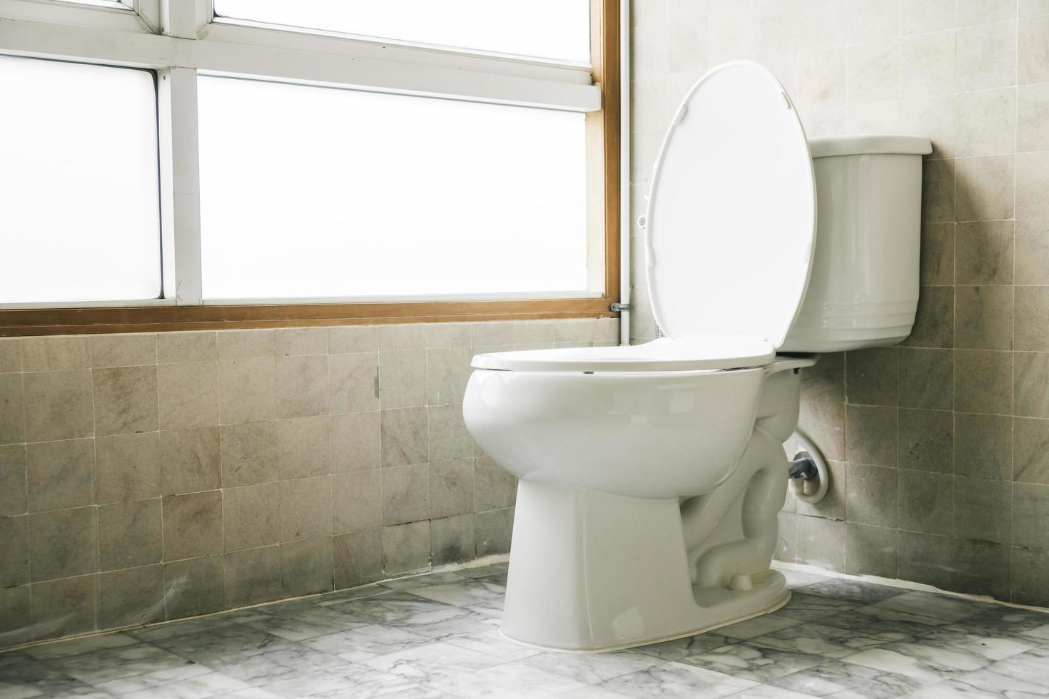 Plumber inspecting or repairing a residential toilet