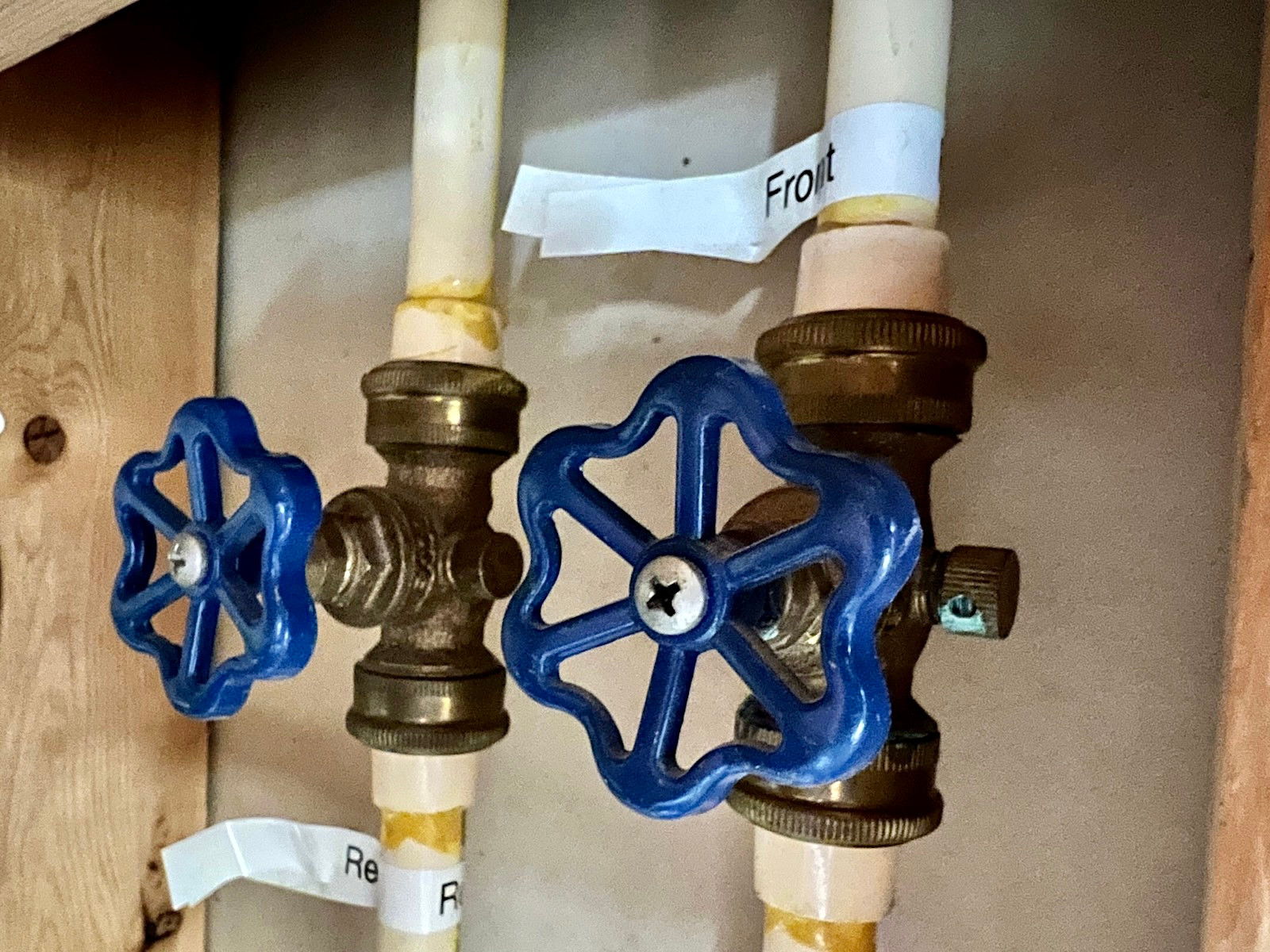 Plumber inspecting a plumbing shut-off valve